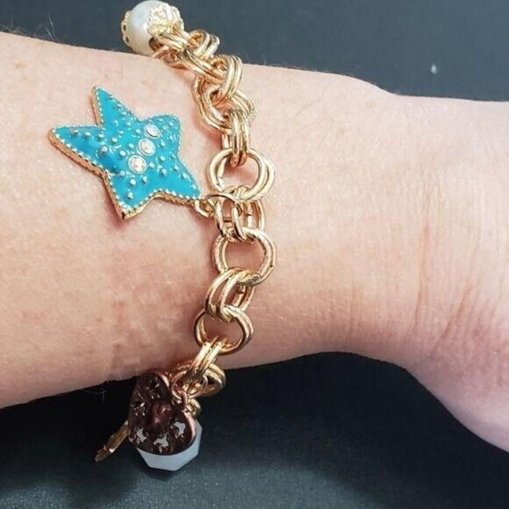 Gold tone by the ocean charm bracelet 7.25"
